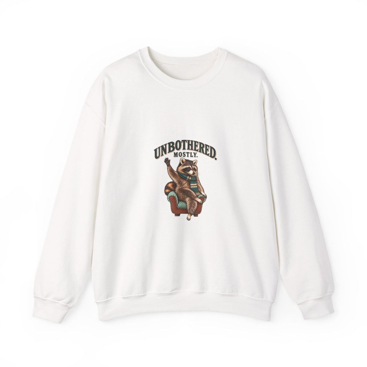 Sand crewneck sweatshirt with Taco the raccoon in an armchair beneath “Unbothered. Mostly.”